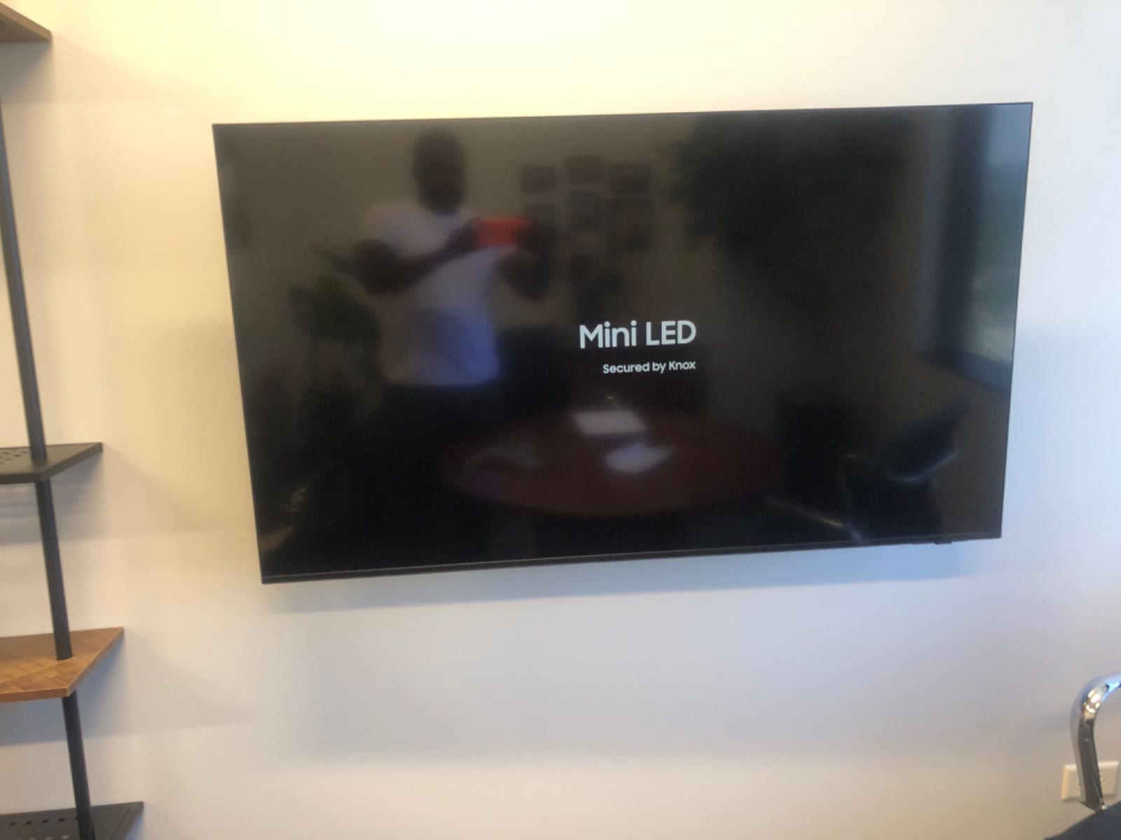 Flat-screen TV mounted on a white wall