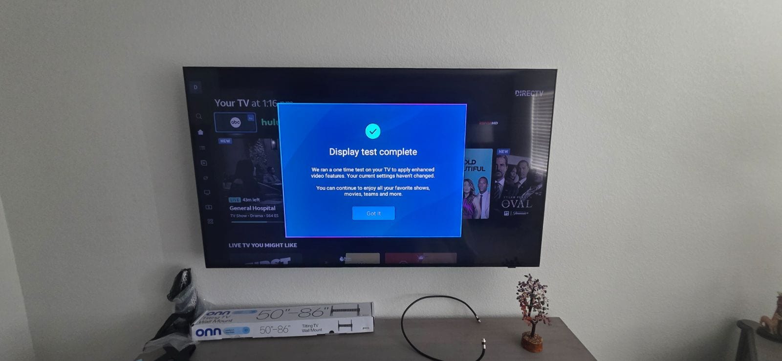 Wall-mounted television with a soundbar beneath it